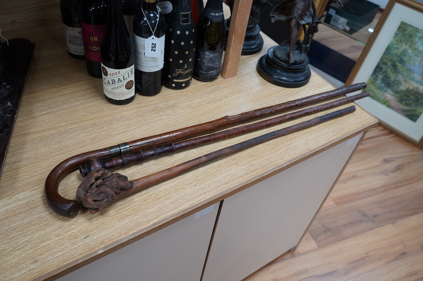 A swordstick and two other walking canes. Condition - fair